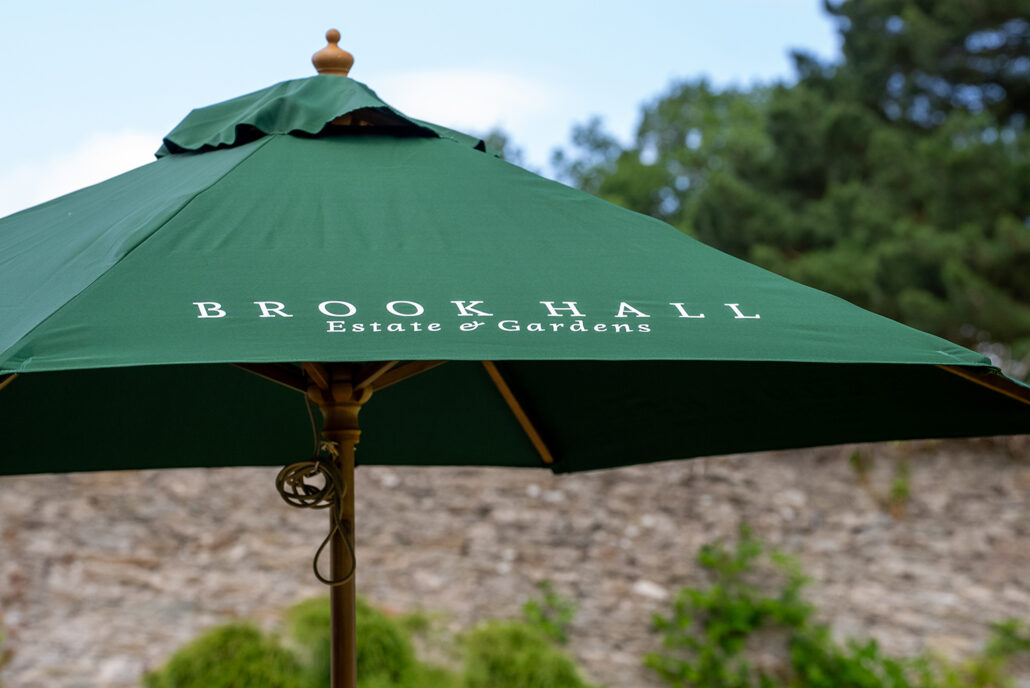 close up of a branded green parasol at brook hall