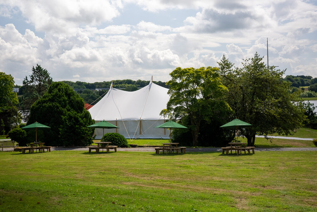 view of the marquee nestled among trees in brook hall
