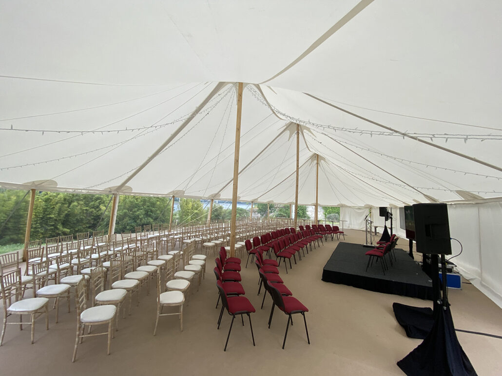 view inside the marquee at brook hall with chairs laid out for an event