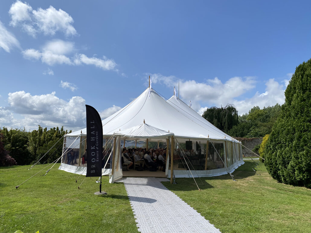 beautiful white marquee set up in brook hall on a sunny day
